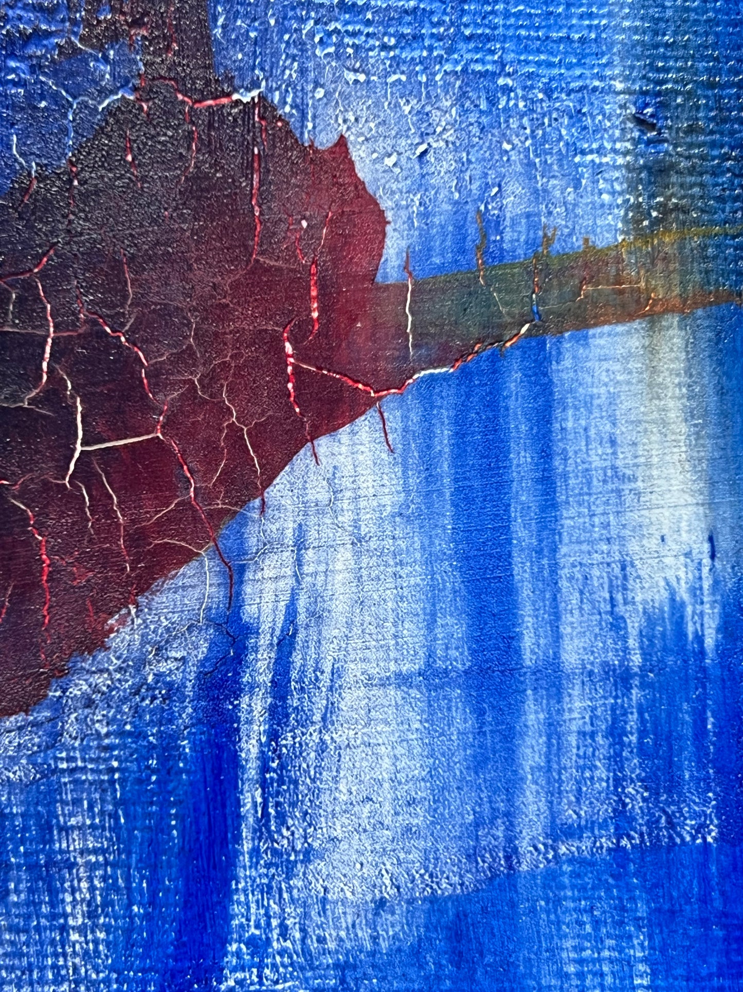 Fractured Echoes, is an oil and acrylic Ink abstract painting by Beatrice Morel. This painting is a hauntingly beautiful exploration of time, memory, and transformation. Featuring deep, moody blues that dominate the canvas, creating an almost infinite expanse that feels like the depths of the ocean or the vastness of a twilight sky. Against this backdrop, fiery reds and earthy browns emerge, their forms fractured and disrupted, as if something once whole has begun to break apart and decay. A close up