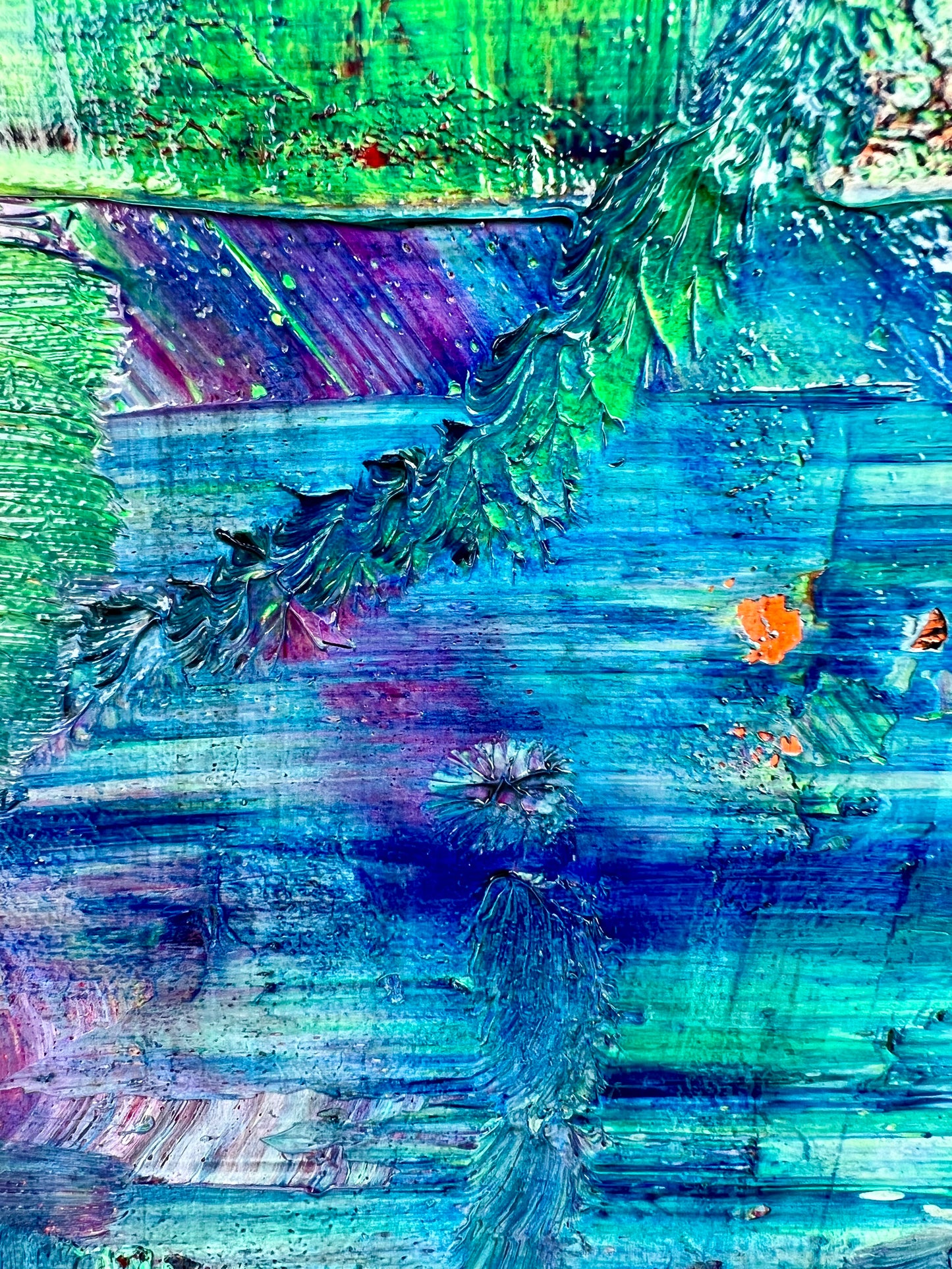 Rise and Fall An oil based abstract painting Beatrice Morel featuring various shades of blue. In the heart of the painting, a mesmerizing interplay of red and yellow emerges, forming the focal point of the composition. This is a close up.