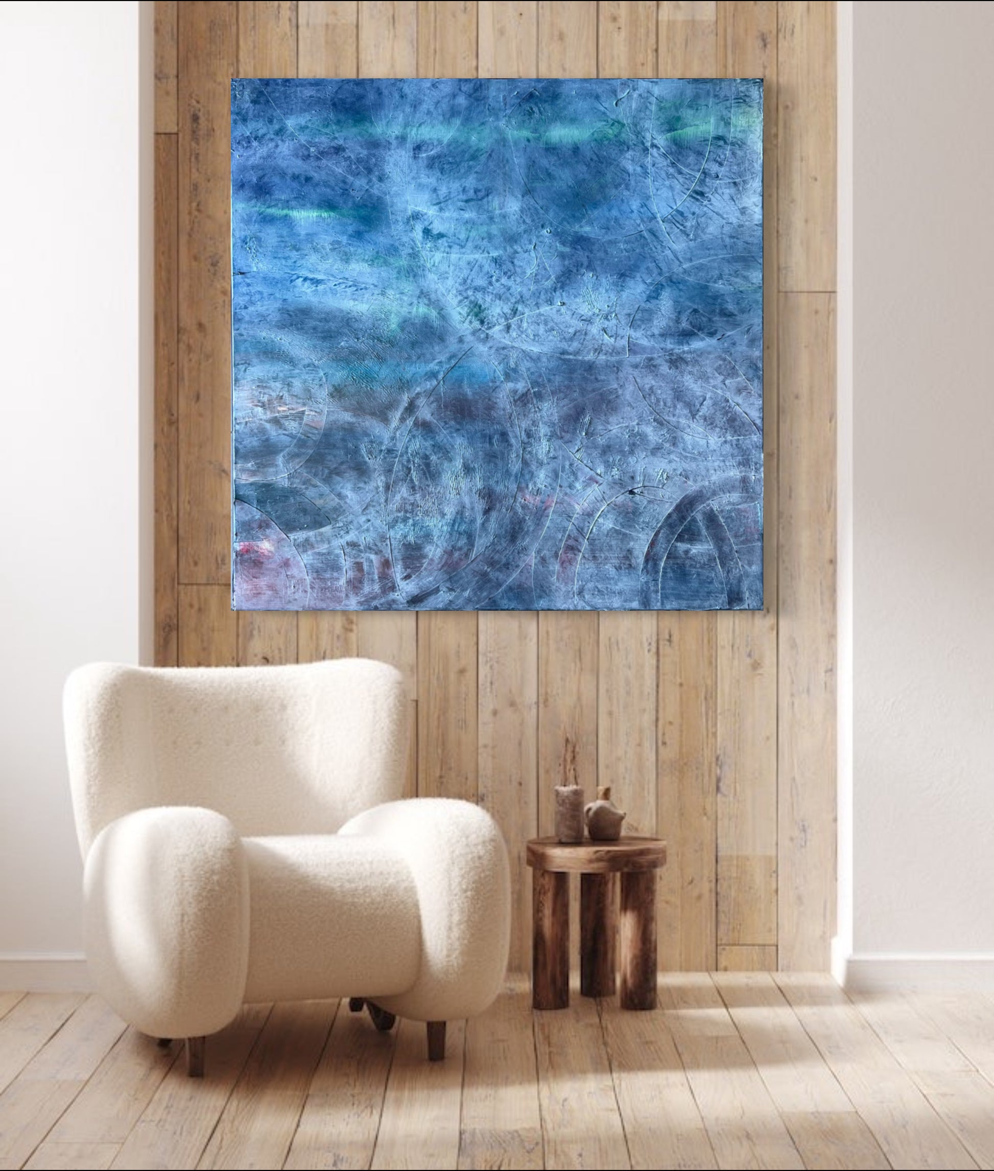 A room setting with Enigma, an oil based abstract painting by Beatrice Morel, featuring blue-gray and light blues.
