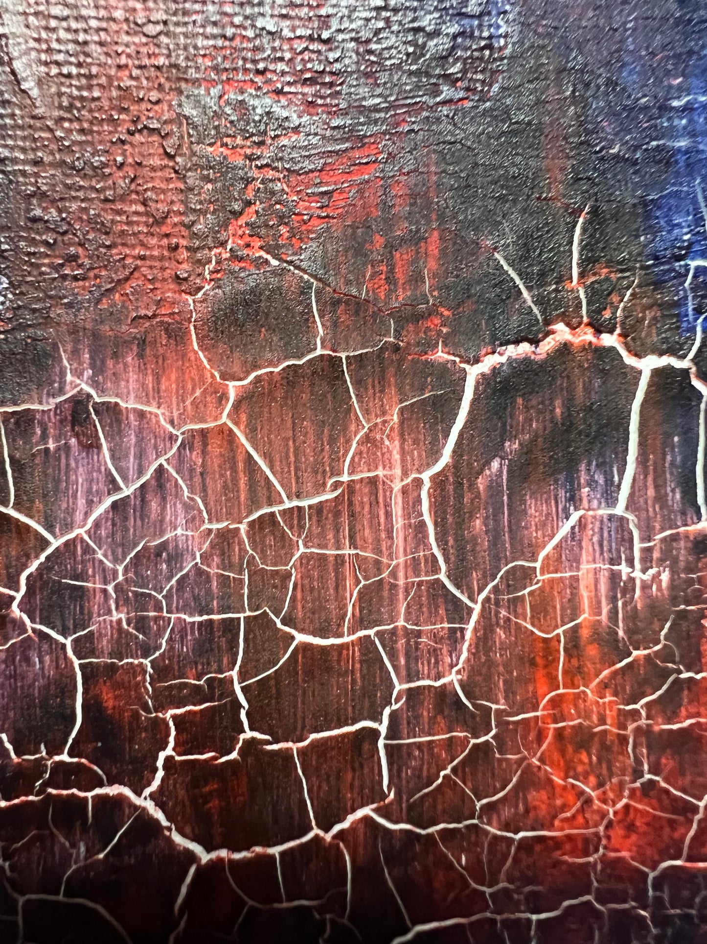 Fractured Echoes, is an oil and acrylic Ink abstract painting by Beatrice Morel. This painting is a hauntingly beautiful exploration of time, memory, and transformation. Featuring deep, moody blues that dominate the canvas, creating an almost infinite expanse that feels like the depths of the ocean or the vastness of a twilight sky. Against this backdrop, fiery reds and earthy browns emerge, their forms fractured and disrupted, as if something once whole has begun to break apart and decay. A close up
